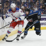 
              New York Rangers' Jonny Brodzinski, left, and Columbus Blue Jackets' Andrew Peeke chase the puck during the first period of an NHL hockey game on Monday, Jan. 16, 2023, in Columbus, Ohio. (AP Photo/Jay LaPrete)
            