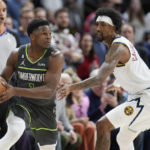 
              Minnesota Timberwolves guard Anthony Edwards, left, looks to pass the ball as Denver Nuggets guard Kentavious Caldwell-Pope defends during the second half of an NBA basketball game Wednesday, Jan. 18, 2023, in Denver. (AP Photo/David Zalubowski)
            
