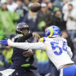 
              Seattle Seahawks quarterback Geno Smith, left, throws under pressure from Los Angeles Rams linebacker Leonard Floyd during the second half of an NFL football game Sunday, Jan. 8, 2023, in Seattle. (AP Photo/Stephen Brashear)
            