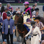 
              Bruce Lunsford, third from left, owner of the horse Art Collector, stands in the winner's circle with jockey Junior Alvarado after Art Collector won the Pegasus World Cup Invitational horse race, Saturday, Jan. 28, 2023, at Gulfstream Park in Hallandale Beach, Fla. (AP Photo/Lynne Sladky)
            
