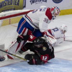 
              Ottawa Senators right wing Alex DeBrincat (12) slides into Montreal Canadiens goaltender Sam Montembeault (35) after being brought down by Canadiens defenseman Mike Matheson (8) during first-period NHL hockey game action Saturday, Jan. 28, 2023, in Ottawa, Ontario. (Adrian Wyld/The Canadian Press via AP)
            