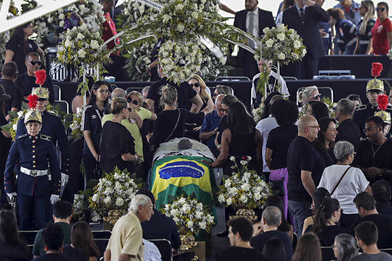 People pay their last respects to the late Brazilian soccer great Pele whose lies in state at Vila ...