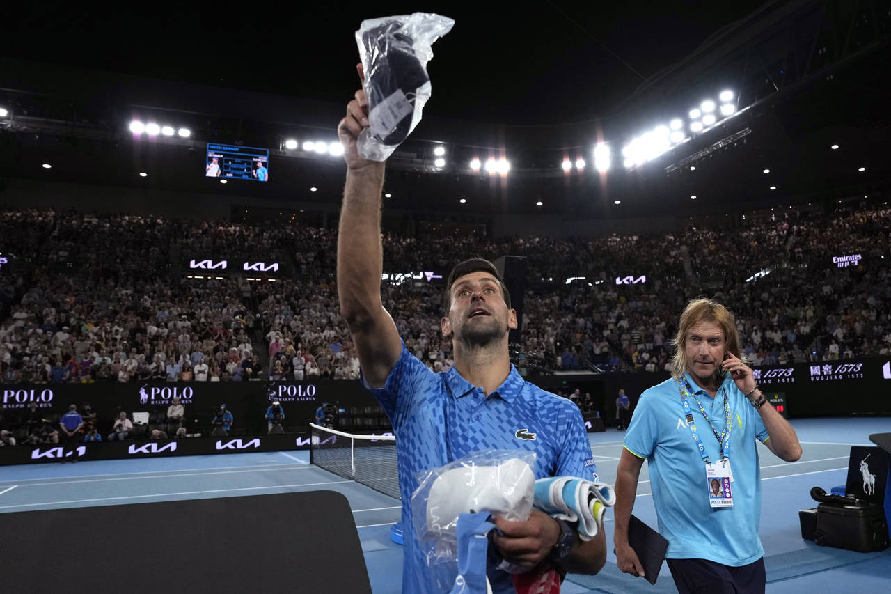 Novak Djokovic of Serbia throws gifts to the crowd following his fourth round win over Alex de Mina...