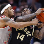 
              Ohio State guard Roddy Gayle, left, fouls Purdue guard David Jenkins during the second half of an NCAA college basketball game in Columbus, Ohio, Thursday, Jan. 5, 2023. Purdue on 71-69. (AP Photo/Paul Vernon)
            