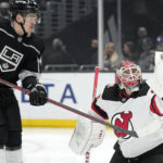 
              New Jersey Devils goaltender Mackenzie Blackwood, right, makes a glove save as Los Angeles Kings defenseman Mikey Anderson watches during the second period of an NHL hockey game Saturday, Jan. 14, 2023, in Los Angeles. (AP Photo/Mark J. Terrill)
            