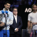 
              Novak Djokovic, left, of Serbia holds the Norman Brookes Challenge Cup as he makes a post match speech after defeating Stefanos Tsitsipas of Greece in the men's singles final at the Australian Open tennis championship in Melbourne, Australia, Sunday, Jan. 29, 2023.(AP Photo/Dita Alangkara)
            