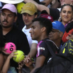 
              Felix Auger-Aliassime of Canada poses for a photo with fans after defeating Francisco Cerundolo of Argentina in their third round match at the Australian Open tennis championship in Melbourne, Australia, Friday, Jan. 20, 2023. (AP Photo/Ng Han Guan)
            