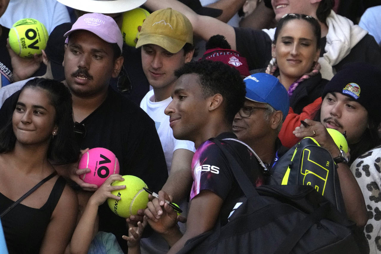 Felix Auger-Aliassime of Canada poses for a photo with fans after defeating Francisco Cerundolo of ...
