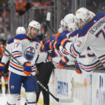 
              Edmonton Oilers' Connor McDavid (97) is congratulated for his goal during the first period of the team's NHL hockey game against the Anaheim Ducks on Wednesday, Jan. 11, 2023, in Anaheim, Calif. (AP Photo/Jae C. Hong)
            
