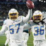 
              Los Angeles Chargers linebacker Amen Ogbongbemiga (57) and cornerback Ja'Sir Taylor (36) celebrate a fumble recovery against the Jacksonville Jaguars during the first half of an NFL wild-card football game, Saturday, Jan. 14, 2023, in Jacksonville, Fla. (AP Photo/John Raoux)
            