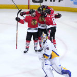 
              Chicago Blackhawks' Seth Jones, center, celebrates his overtime, game winning goal with Tyler Johnson, left, and Andreas Athanasiou as Buffalo Sabres goaltender Craig Anderson skates to his bench during an NHL hockey game Tuesday, Jan. 17, 2023, in Chicago. (AP Photo/Charles Rex Arbogast)
            
