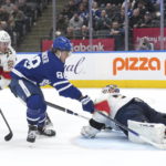 
              Toronto Maple Leafs forward William Nylander (88) scores against Florida Panthers goaltender Sergei Bobrovsky (72) as forward Carter Verhaeghe (23) watches during overtime in an NHL hockey game Tuesday, Jan. 17, 2023, in Toronto. (Nathan Denette/The Canadian Press via AP)
            