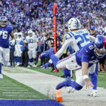 
              New York Giants' Daniel Jones (8) dives past Indianapolis Colts' Rodney Thomas II (25) for a touchdown during the second half of an NFL football game, Sunday, Jan. 1, 2023, in East Rutherford, N.J. (AP Photo/Bryan Woolston)
            