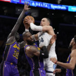 
              Memphis Grizzlies forward Dillon Brooks (24) fouls Los Angeles Lakers forward LeBron James (6) during the first half of an NBA basketball game in Los Angeles, Friday, Jan. 20, 2023. (AP Photo/Ashley Landis)
            