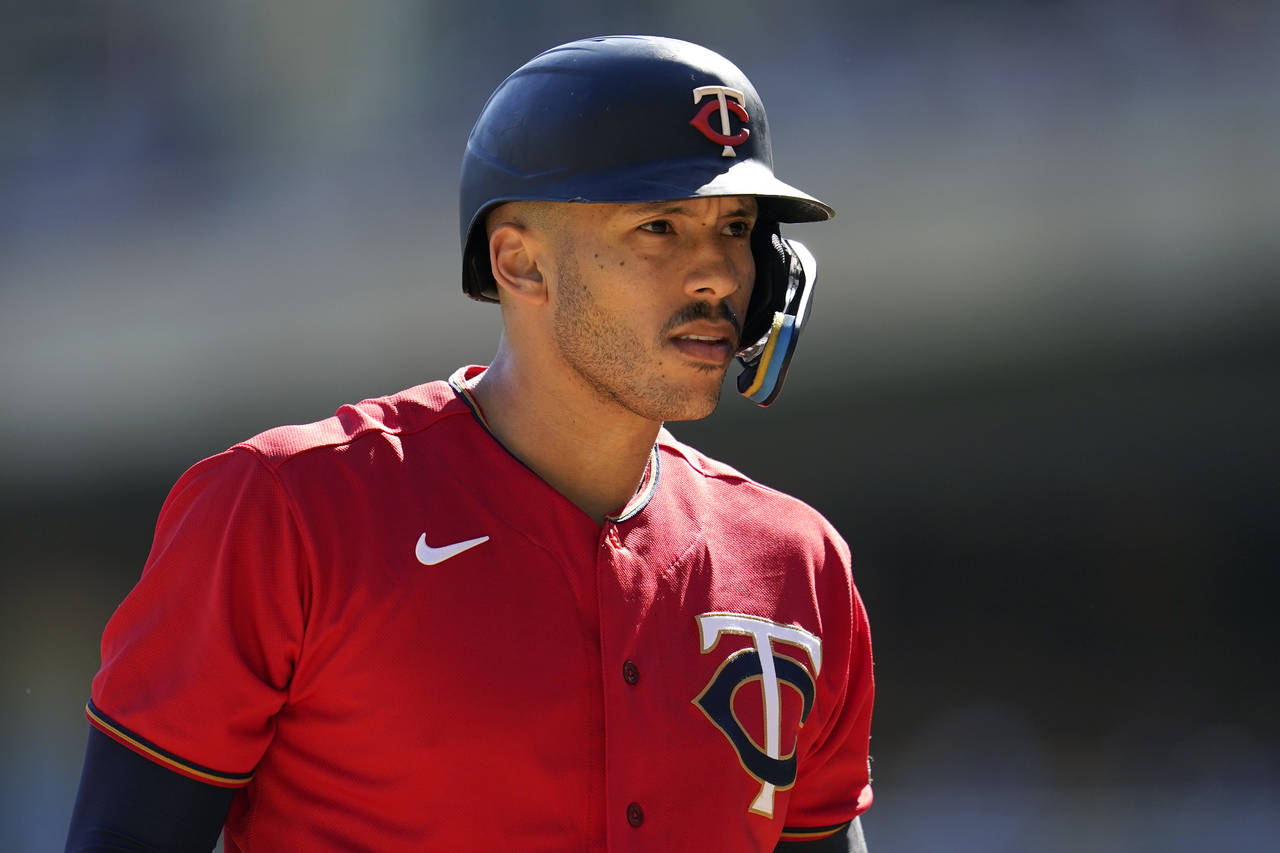 FILE - Minnesota Twins' Carlos Correa reacts while batting during the first inning of a baseball ga...