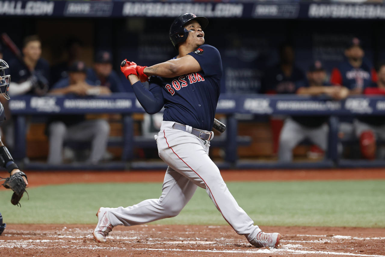 FILE - Boston Red Sox's Rafael Devers watches his RBI-single against the Tampa Bay Rays during the ...