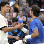 
              Ben Shelton, left, of the U.S. is congratulated by compatriot J.J. Wolf following their fourth round match at the Australian Open tennis championship in Melbourne, Australia, Monday, Jan. 23, 2023. (AP Photo/Ng Han Guan)
            