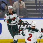 
              Minnesota Wild center Joel Eriksson Ek (14) celebrates after his goal with defenseman Calen Addison (2) during the third period of an NHL hockey game against the Buffalo Sabres, Saturday, Jan. 7, 2023, in Buffalo, N.Y. (AP Photo/Jeffrey T. Barnes)
            