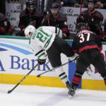 
              Dallas Stars' Jason Robertson (21) attempts to gain control of the puck under pressure from Carolina Hurricanes right wing Andrei Svechnikov (37) during the first period of an NHL hockey game Wednesday, Jan. 25, 2023, in Dallas. (AP Photo/Tony Gutierrez)
            