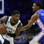 
              Brooklyn Nets' Kyrie Irving, left, tries to get past Philadelphia 76ers' De'Anthony Melton during the first half of an NBA basketball game, Wednesday, Jan. 25, 2023, in Philadelphia. (AP Photo/Matt Slocum)
            
