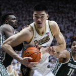 
              Purdue center Zach Edey (15) moves to the basket between Michigan State center Mady Sissoko (22) and guard A.J. Hoggard (11)during the second half of an NCAA college basketball game in West Lafayette, Ind., Sunday, Jan. 29, 2023. Purdue defeated Michigan State 77-61. (AP Photo/Michael Conroy)
            