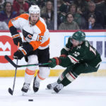 
              Philadelphia Flyers center Kevin Hayes (13), left, and Minnesota Wild left wing Matt Boldy (12) battle for the puck during the first period of an NHL hockey game Thursday, Jan. 26, 2023, in St. Paul, Minn. (AP Photo/Abbie Parr)
            