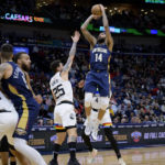 
              New Orleans Pelicans forward Brandon Ingram (14) shoots over Minnesota Timberwolves guard Austin Rivers (25) during the first half of an NBA basketball game in New Orleans, Wednesday, Jan. 25, 2023. (AP Photo/Matthew Hinton)
            