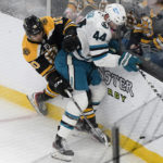 
              Boston Bruins left wing A.J. Greer (10) vies for control of the puck with San Jose Sharks defenseman Marc-Edouard Vlasic (44) as they crash into the boards in the first period of an NHL hockey game, Sunday, Jan. 22, 2023, in Boston. (AP Photo/Steven Senne)
            