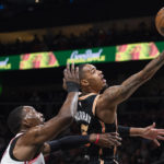 
              Atlanta Hawks guard Dejounte Murray, right, goes up to score against Miami Heat center Bam Adebayo during the first half of an NBA basketball game, Monday, Jan. 16, 2023, in Atlanta. (AP Photo/Hakim Wright Sr.)
            