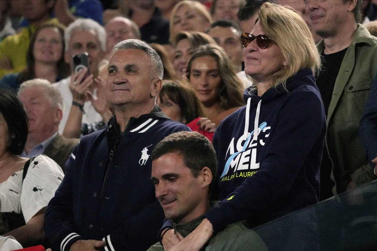 The parents of Novak Djokovic of Serbia, father Srdjan and mother Dijana react during his post matc...