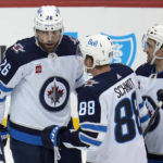 
              Winnipeg Jets right wing Blake Wheeler (26) is congratulated for his goal against the Pittsburgh Penguins during the first period of an NHL hockey game  in Pittsburgh, Friday, Jan. 13, 2023. (AP Photo/Gene J. Puskar)
            