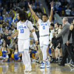 
              UCLA guard Tyger Campbell (10) and guard Jaylen Clark (0) celebrate during a timeout during the second half of an NCAA college basketball game against Colorado in Los Angeles, Saturday, Jan. 14, 2023. (AP Photo/Ashley Landis)
            
