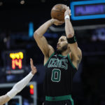 
              Boston Celtics forward Jayson Tatum, right, shoots over Charlotte Hornets guard LaMelo Ball during the second half of an NBA basketball game in Charlotte, N.C., Monday, Jan. 16, 2023. (AP Photo/Nell Redmond)
            