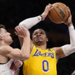 
              Los Angeles Lakers guard Russell Westbrook, right, shoots as Miami Heat guard Tyler Herro defends during the first half of an NBA basketball game Wednesday, Jan. 4, 2023, in Los Angeles. (AP Photo/Mark J. Terrill)
            