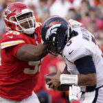 
              FILE - Kansas City Chiefs defensive tackle Chris Jones (95) hits Denver Broncos quarterback Russell Wilson (3) during an NFL football game Jan. 1, 2023, in Kansas City, Mo. San Francisco 49ers edge rusher Nick Bosa, Jones and Dallas Cowboys edge rusher Micah Parsons are the finalists for AP Defensive Player of the Year. (AP Photo/Ed Zurga, File)
            