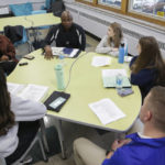 
              Troy Vincent, NFL Executive Vice President of Football Operations, top, speaks members of the "Flag Football United" initiative group at Mount St. Mary Academy on Wednesday, Jan. 18, 2023, in Kenmore, N.Y. (AP Photo/Joshua Bessex)
            