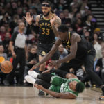 
              Boston Celtics guard Marcus Smart (36) rolls on the floor after an injury as Toronto Raptors forward Pascal Siakam, top right, and guard Gary Trent Jr. (33) look on during first-half NBA basketball game action in Toronto, Saturday, Jan. 21, 2023. (Frank Gunn/The Canadian Press via AP)
            