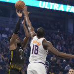 
              Golden State Warriors center Kevon Looney, left, shoots over Phoenix Suns center Bismack Biyombo during the first half of an NBA basketball game in San Francisco, Tuesday, Jan. 10, 2023. (AP Photo/Godofredo A. Vásquez)
            
