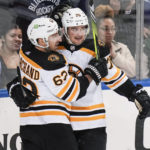 
              Boston Bruins' Connor Clifton, right, celebrates with teammate Brad Marchand after scoring a goal during the third period of an NHL hockey game against the New York Rangers Thursday, Jan. 19, 2023, in New York. The Bruins won 3-1. (AP Photo/Frank Franklin II)
            