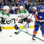 
              New York Islanders' Simon Holmstrom (10) shoots the puck past Dallas Stars' Nils Lundkvist (5) during the second period of an NHL hockey game Tuesday, Jan. 10, 2023, in Elmont, N.Y. (AP Photo/Frank Franklin II)
            