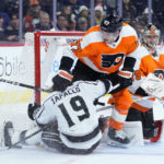 
              Los Angeles Kings' Alex Iafallo (19) collides with Philadelphia Flyers' Tony DeAngelo (77) and Carter Hart (79) during the third period of an NHL hockey game, Tuesday, Jan. 24, 2023, in Philadelphia. (AP Photo/Matt Slocum)
            