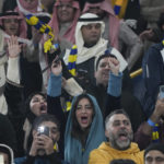 
              Fans react during official presentation of Cristiano Ronaldo as a new member of Al Nassr soccer club in in Riyadh, Saudi Arabia, Tuesday, Jan. 3, 2023.Ronaldo, who has won five Ballon d'Ors awards for the best soccer player in the world and five Champions League titles, will play outside of Europe for the first time in his storied career. (AP Photo/Amr Nabil)
            