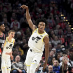 
              Utah Jazz guard Collin Sexton, right, reacts after hitting a shot as Portland Trail Blazers guard Gary Payton II, left, looks on during the first half of an NBA basketball game in Portland, Ore., Wednesday, Jan. 25, 2023. (AP Photo/Steve Dykes)
            