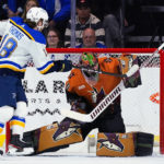 
              Arizona Coyotes goaltender Karel Vejmelka, right, makes a save on a shot by St. Louis Blues center Robert Thomas (18) during the first period of an NHL hockey game in Tempe, Ariz., Thursday, Jan. 26, 2023. (AP Photo/Ross D. Franklin)
            