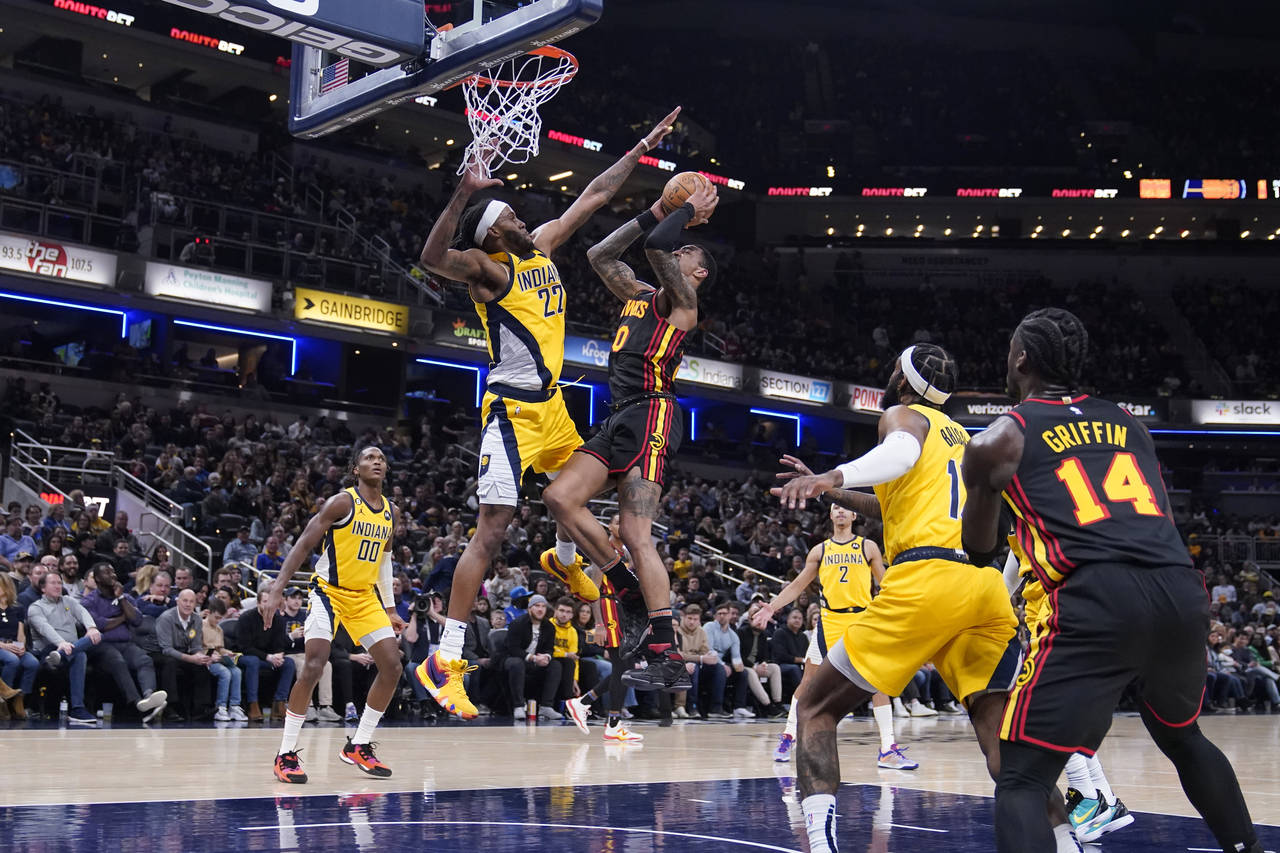 Atlanta Hawks' John Collins (20) shoots against Indiana Pacers' Isaiah Jackson during the first hal...