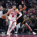
              Chicago Bulls guard Zach LaVine (8) drives against Golden State Warriors guard Jordan Poole, right, during the first half of an NBA basketball game in Chicago, Sunday, Jan. 15, 2023. (AP Photo/Nam Y. Huh)
            