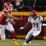 
              Kansas City Chiefs tight end Travis Kelce (87) tosses the ball as Cincinnati Bengals cornerback Mike Hilton (21) looks on during the first half of the NFL AFC Championship playoff football game, Sunday, Jan. 29, 2023, in Kansas City, Mo. (AP Photo/Jeff Roberson)
            