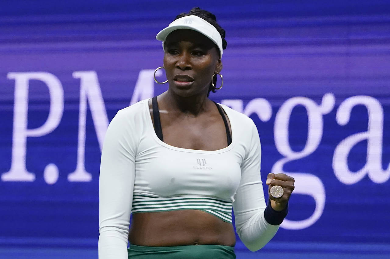 FILE - Venus Williams, of the United States, reacts during her first-round doubles match with Seren...