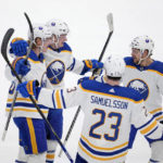 
              Buffalo Sabres' Rasmus Dahlin, left, Casey Mittelstadt, left rear, Mattias Samuelsson (23) and Tyson Jost (17) celebrate after a score by Dahlin in the first period of an NHL hockey game against the Dallas Stars, Monday, Jan. 23, 2023, in Dallas. (AP Photo/Tony Gutierrez)
            