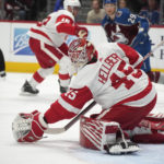
              Detroit Red Wings goaltender Magnus Hellberg (45) makes a glove-save against the Colorado Avalanche in the third period of an NHL hockey game Monday, Jan. 16, 2023, in Denver. (AP Photo/David Zalubowski)
            